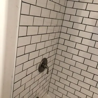 White subway tile shower with bronze valve, bathroom remodel